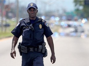 Baton Rouge Police officers patrol Airline Hwy after 3 police officers were killed early this morning on July 17, 2016 in Baton Rouge, Louisiana. According to reports, one suspect has been killed while others are still being sought by police.
