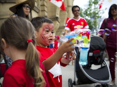 Three-year-old Suliman Abdulaziz shoots a bubble gun on Wellington Street during Canada Day festivities in downtown Ottawa, Friday, July 1, 2016.