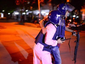 A Bangladeshi policeman that was injured during an attack on an upscale restaurant is helped by a colleague in Dhaka on July 1, 2016.  Heavily armed militants murdered 20 hostages in Bangladesh, hacking many of their victims to death, before six of the attackers were gunned down at the end of a siege July 2 at a restaurant packed with foreigners. As the Islamic State (IS) group claimed responsibility for the carnage at the start of the Eid holiday, Prime Minister Sheikh Hasina said she was determined to eradicate militancy in the mainly Muslim nation.  /