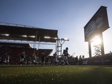 Toronto Argonauts players leave the field after warm-ups.