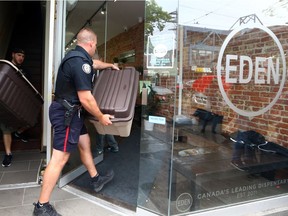 Toronto Police remove boxes believe to be containing marijuana after Toronto Police raided Eden on Queen St during a series of raids on marijuana dispensaries across Toronto on Thursday May 26, 2016. Dave Abel/Toronto Sun/Postmedia Network