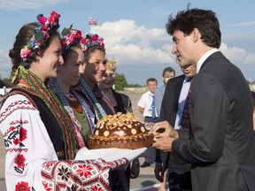 Canadian Prime Minister Justin Trudeau is greeted by women in traditional dress and bread as he arrives in Kiev, Ukraine. THE CANADIAN PRESS/Adrian Wyld ORG