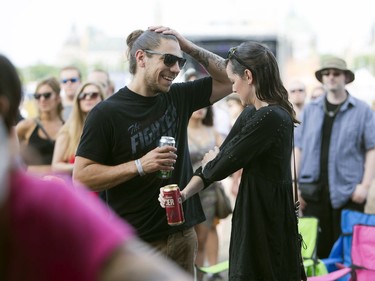 Two fans react to water spilling off the City Stage for a good soaking.