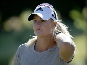 Anna Nordqvist of Sweden looks on after being assessed a two-stroke penalty for grounding her club in a bunker on the 17th hole.