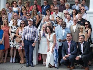 U.S. Ambassador Bruce Heyman and Mrs. Vicki Heyman (centre crouching) pose for a group photo as they host the annual Fourth of July Independence Day celebration on the grounds of Lornado, the U.S. ambassador's official residence.