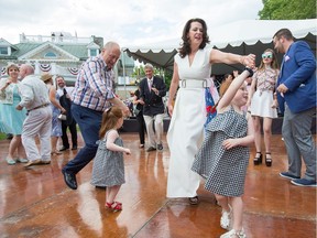 U.S. Ambassador Bruce Heyman and his wife, Vicki, dance with their granddaughters as they host the annual Fourth of July Independence Day celebration on the grounds of Lornado, the ambassador's official residence.