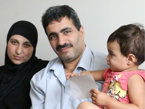 Wael Aun and his wife, Wafaa Aon and their two-year-old daughter, Mariam in their new Ottawa apartment.