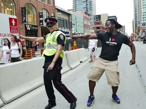 Yves Soglo dances with a member of Ottawa Police Service (Tracey Turpin) on Canada Day, July 1, 2016.