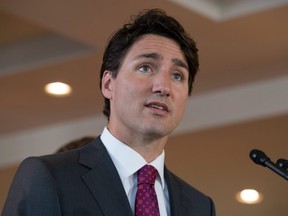 Canadian Prime Minister Justin Trudeau listens to a question as he speaks with the media following a child care benefit announcement Wednesday July 20, 2016 in Aylmer, Que.