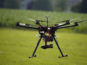 FILE - In this June 11, 2015, file photo, a hexacopter drone is flown during a drone demonstration at a farm and winery on potential use for board members of the National Corn Growers in Cordova, Md. NASA is entering the next phase of a plan to draw up rules of the road for small drones that fly under 500 feet. The NASA project is meant to develop performance standards for drones that would be used for commercial purposes. (AP Photo/Alex Brandon, File)