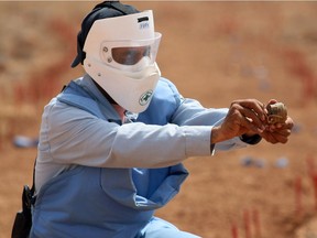 A deminer defuses the explosive part of a landmine on the Jordanian side of the Jordan-Syria Jaber border in 2008.