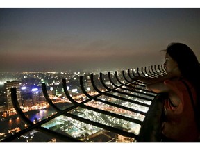 A woman watches the view from an observation deck of the Cairo Tower in Egypt, Wednesday, Aug. 17, 2016.