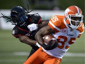 B.C. Lions Shawn Gore (85) keeps the ball from Ottawa Redblacks Abdul Kanneh (14) during first half CFL action on Thursday, Aug. 25, 2016 in Ottawa.