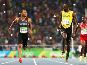 Andre de Grasse of Canada and Usain Bolt of Jamaica react as they compete in the Men's 200m Semifinals .