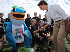 Trudeau chats with the girls soccer team prior to the coin toss on the soccer pitch at the Newfoundland and Labrador Summer Games in Conception Bay South, N.L, on August 15, 2016. THE CANADIAN PRESS/Paul Daly