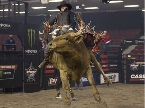 Aylmer, Ont. cowboy Dusty McMullen rides Conviction at Saturday's PBR Bullriding show at TD Place Arena.