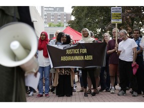 Activists demonstrate in front of Ottawa police headquarters on Elgin Street on on Wednesday.