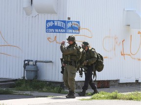 Police surround a building on High Street in Carleton Place while investigating a possible bomb threat. A man was taken into custody. Monday Aug 15, 2016.