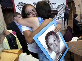 Bridget Tolley, whose mother Gladys was killed in 2001, is embraced after the announcement of the inquiry into Murdered and Missing Indigenous Women at the Museum of History in Gatineau, Quebec on Wednesday.