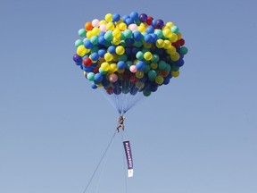 Caroline Lapensée floats with balloons above Lansdowne Park to promote Ottawa 2017.