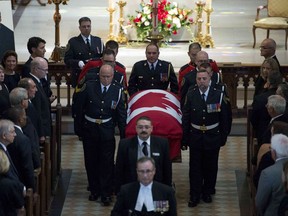 Catherine Belanger, wife of MP Mauril Belanger, (second from right), Prime Minister Justin Trudeau (third from left), dignitaries, MPs and family members look on as Belanger's casket leaves the Notre-Dame Cathedral Basilica during his funeral, on Saturday, Aug. 27, 2016 in Ottawa.