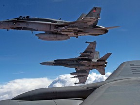 Royal Canadian Air Force CF-188 Hornets are refueled by a KC-135 Stratotanker assigned to the 340th Expeditionary Air Refueling Squadron on October 30, 2014, over Iraq. USAF photo