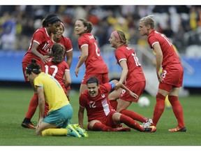 Canada's Christine Sinclair, centre, celebrates with teammates after scoring her team's second goal during the 2016 Summer Olympics football match in Sao Paulo, Brazil, on Wednesday. Canada won 2-0.