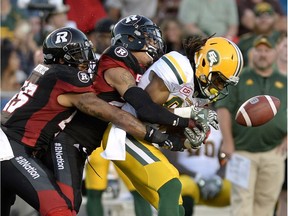 The Edmonton Eskimos' Derel Walker (87) fumbles the ball as two Ottawa Redblacks wrap him up during the first half in a game on Saturday, Aug. 6, 2016 at TD Place stadium.