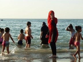 A file picture taken on August 3, 2016 shows Algerians gathering on a public beach, reserved for families in the capital Algiers. The debate launched this summer in France over the Burkini is not causing such a stir in North Africa where the Islamic swimsuit is uncontroversial as the dress-code on the beaches has become increasingly prudish.  /