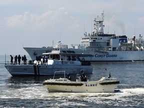 This photo taken on July 13 shows the Japanese Coast Guard ship PLH02 Tsugaru (background) with a Philippine Coast Guard boat (C) during their annual joint anti-piracy exercise in the waters off Manila Bay, a day after a UN-backed tribunal declared China has no "historic rights" in the South China Sea. China doesn't care.