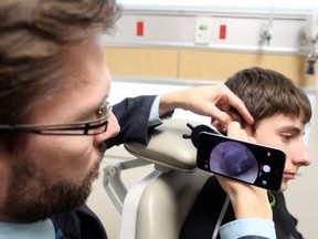 Dr. Matthew Bromwich use his smartphone to take a photo of Adoni Vassilyadi inner ear on Thursday, Apr. 14, 2016 at The Children's Hospital of Eastern Ontario in Ottawa, Ontario.