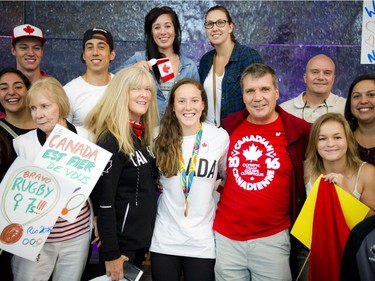 Gatineau's bronze medalist Natasha Watcham-Roy was welcomed home by friends and family at the Ottawa Macdonald–Cartier International Airport Tuesday August 23, 2016. The middle of the photo is her mother Kathryn Watcham, Natasha Watcham-Roy and her father Yvan Roy.