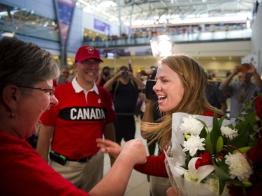 Gold medalist Erica Wiebe goes to hug her mother Paula Preston after returning from the Olympics in Rio to Ottawa at the Ottawa Macdonald–Cartier International Airport Tuesday August 23, 2016.