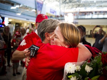 Gold medalist Erica Wiebe hugs her mother Paula Preston after returning from the Olympics in Rio to Ottawa at the Ottawa Macdonald–Cartier International Airport Tuesday August 23, 2016.