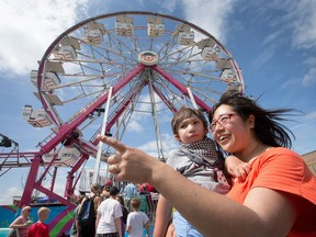 Haishan Chen with her son Quinlan Statia, 4 1/2, take in the sites at the Capital Fair at the Rideau Carleton Raceway last year. The Fair runs from Aug. 19 to the following weekend.