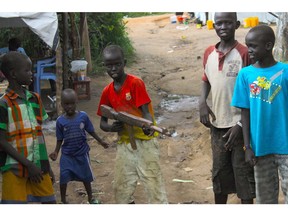 In this July 25, 2016 photo, a group of children at the UN protection of civilians site in Juba, South Sudan, play with a makeshift gun. South Sudan's government has recruited child soldiers in the past week to prepare for a renewed conflict, according to an internal United Nations document. Many of Africa's wars depend on the recruitment of children as soldiers.