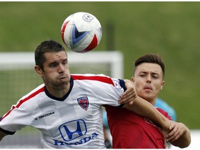 Indy Eleven's Greg Janicki, left, and Ottawa Fury FC's Ryan Williams, right, battle for the ball during the fist half of play at TD Place Stadium Sunday, August 28, 2016.