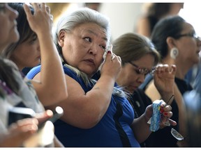 Joan Friesen, whose family member Donna Navvaq Kusugak died in 2003, wipes her eyes during the announcement of the inquiry into Murdered and Missing Indigenous Women at the Museum of History in Gatineau, Quebec on Wednesday.