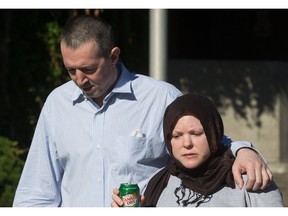 John Nuttall, left, and Amanda Korody, who had terrorism charges against them thrown out in B.C. Supreme Court earlier in the day, leave jail after being re-arrested and placed under a peace bond and released again, after a judge ruled the couple were entrapped by the RCMP in a police-manufactured crime, in Vancouver, B.C., on Friday July 29, 2016.