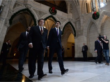 Prime Minister Justin Trudeau arrives at a caucus meeting with Liberal MP Mauril Belanger on Parliament Hill in Ottawa on Wednesday, Dec. 2, 2015.