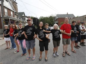 This 2014 photo shows Little Italy residents, including lawyer Jamie Liew, centre, who opposed a developer's plan to build a nine-storey condo on a short, narrow dead-end street.