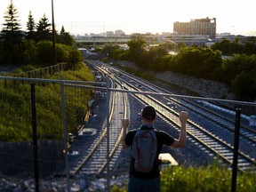 A journalist walks the line: Matthew Pearson looks at the LRT tracks under construction by the intersection of Belfast Road and Tremblay Road in Ottawa. Tuesday, Aug. 23, 2016. (James Park)