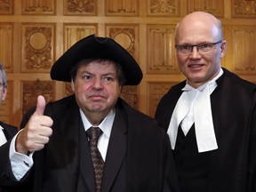 Liberal MP Mauril Belanger gives the thumbs-up as he wears the House of Commons Speaker's tricorn hat as Speaker Geoff Regan (right) looks on on Parliiament Hill, in Ottawa, Wednesday March 9, 2016.