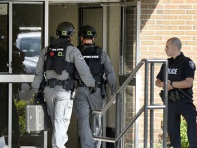 Ottawa Police tactical officers enter 1993 Jasmine Crescent after reports of a gunshot, in Ottawa on Tuesday, August 2, 2016.