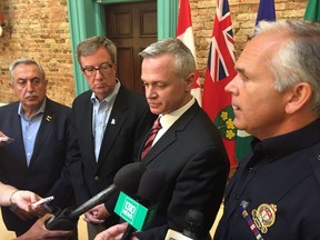 From left: Police services board chair Eli El-Chantiry, Mayor Jim Watson, Ottawa Police Association president Matt Skof and Ottawa police Chief Charles Bordeleau speak after meeting in the mayor's office on Thursday.