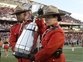 RCMP officers carry the Grey Cup as Ottawa is announced as the host of the 2017 Grey Cup championship, before CFL action between the Ottawa Redblacks and the Toronto Argonauts, in Ottawa on Sunday, July 31, 2016.
