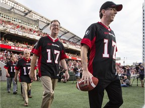 Roger Greenberg, managing partner of the Ottawa Sports and Entertainment Group, walks with Mayor Jim Watson onto the field at TD Place in July 2016 when the CFL announced Ottawa as the 2017 Grey Cup host.