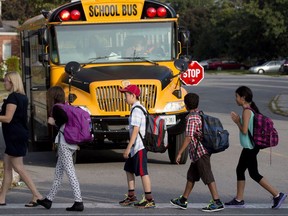Schoolchildren walk to their bus.
