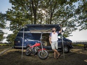 Simon Stiles is photographed with the 1992 Dodge E-350 he calls home, at Bate Island on the Ottawa River, Thursday, Aug. 11, 2016.