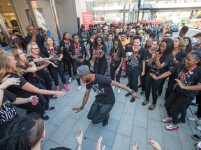 Staff of H&M entertain large lines of people waiting to get intothe store during the grand opening of the Rideau Centre expansion ahead of the 10:15am opening.